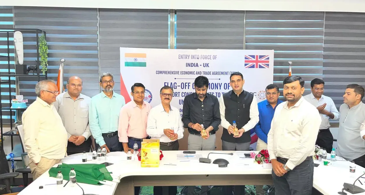 People gathered at the flag-off ceremony of export consignments to the United Kingdom, two of them holding bottles of Goli Pop Soda
